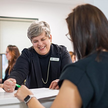 Dentistry team member shaking hands with dental patient