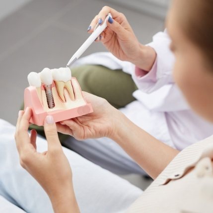 Dentist describing the benefits of dental implants