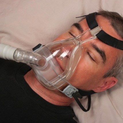 Man receiving sleep apnea treatment