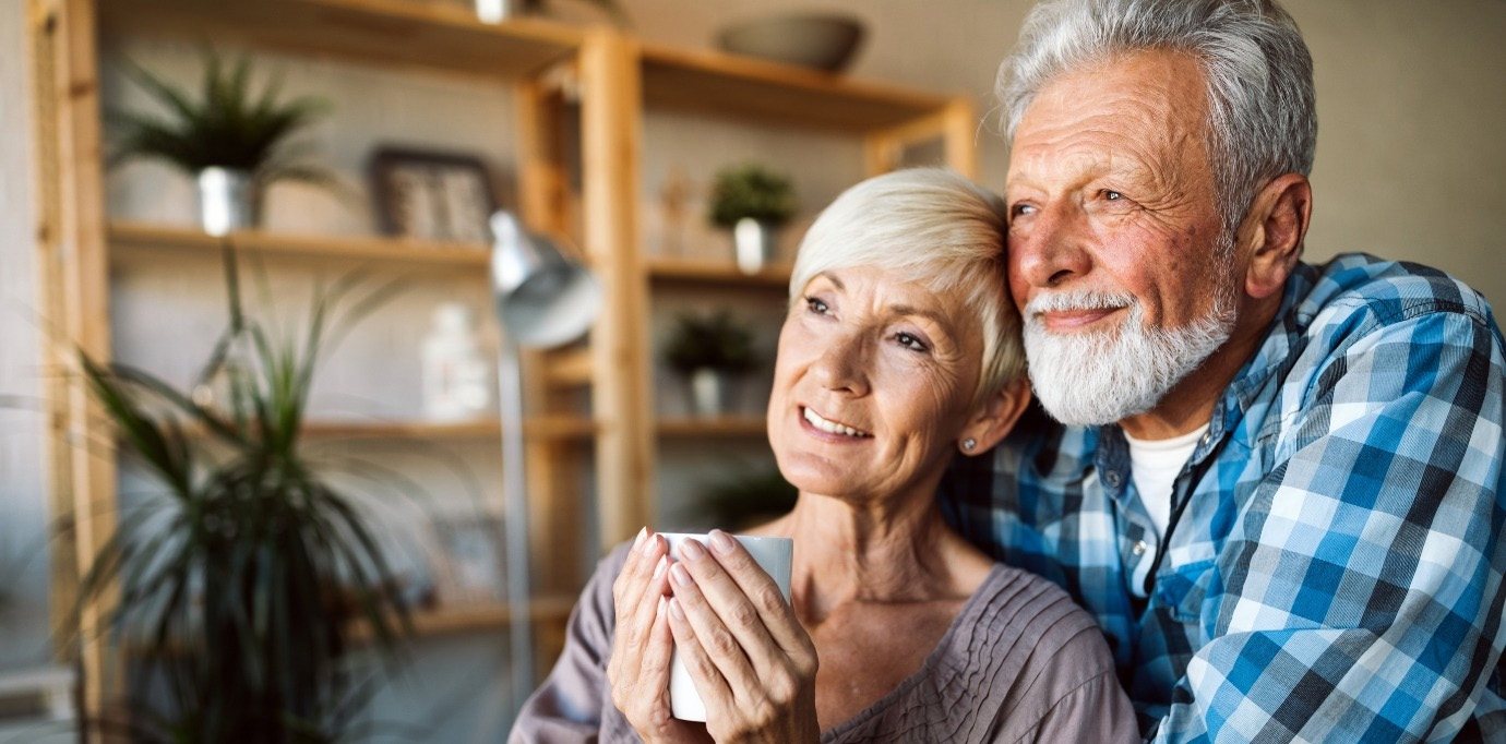 Smiling senior man and woman looking off into the distance together