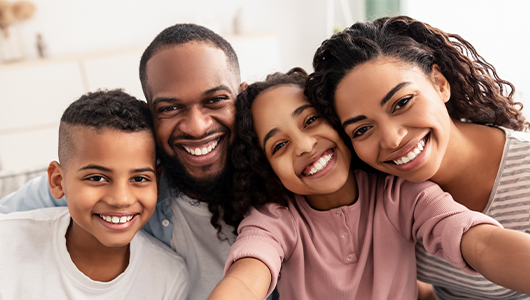 Family of four grinning
