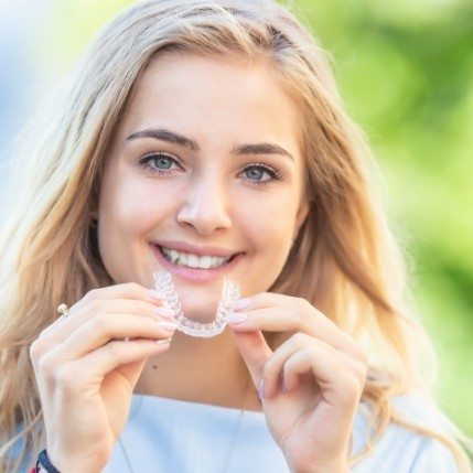 Dental patient placing an Invisalign tray