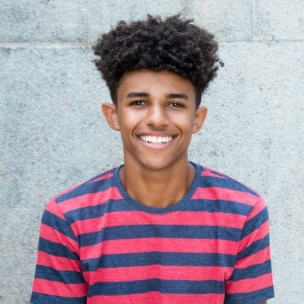 Young man with straight smile thanks to Invisalign clear aligners