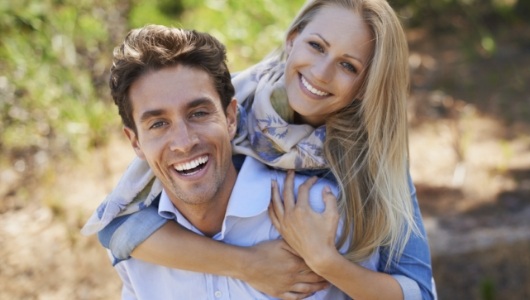 Man and woman smiling after restorative dentistry