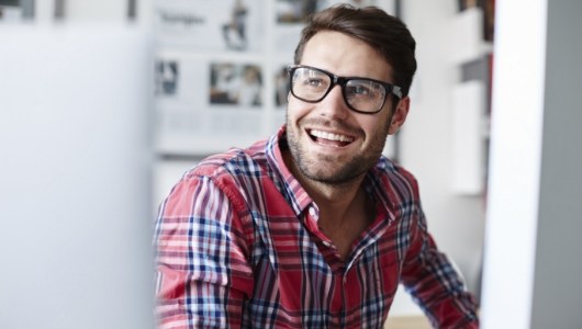 Man smiling after replacing missing teeth