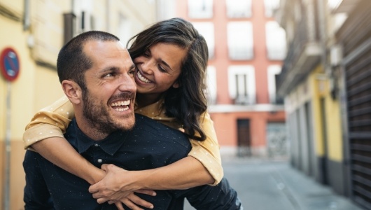 Man and woman with healthy smiles after emergency dentistry