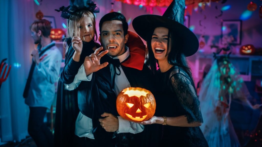 family dressed in Halloween costumes at party